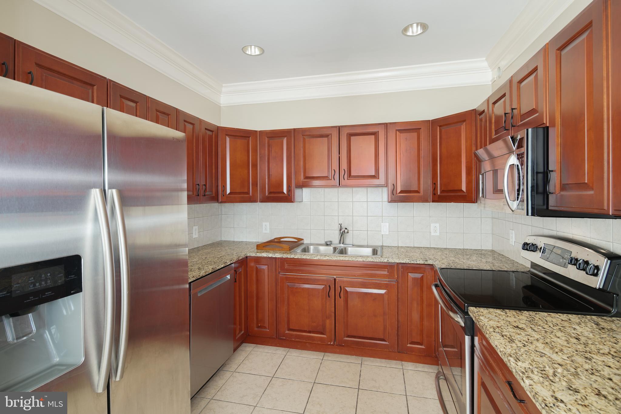 901 North Penn Street, Unit R1902 Philadelphia, PA 19123 - Photo 11 of 34 a kitchen with a sink a refrigerator and cabinets