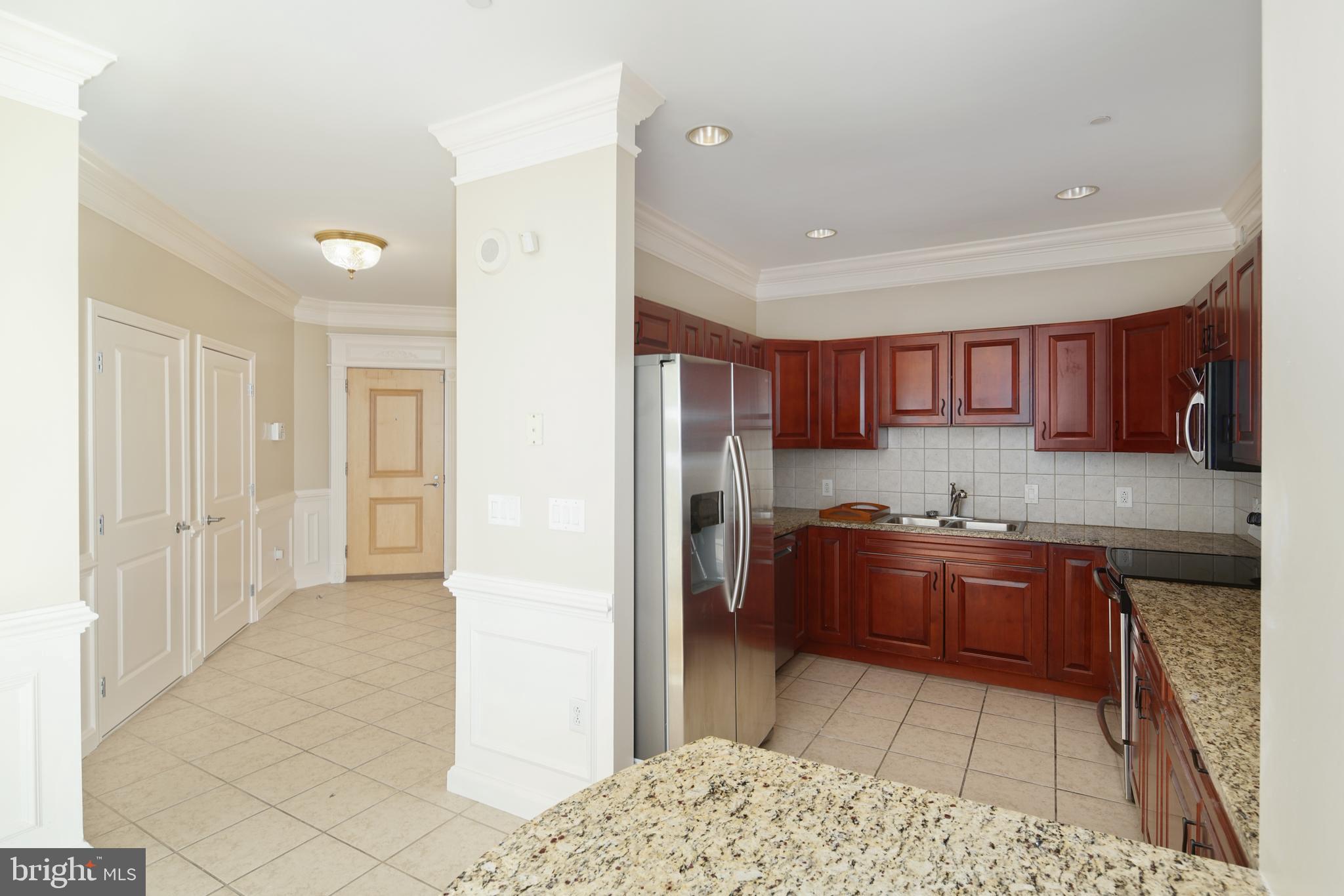 901 North Penn Street, Unit R1902 Philadelphia, PA 19123 - Photo 12 of 34 a kitchen with stainless steel appliances granite countertop a refrigerator and a sink