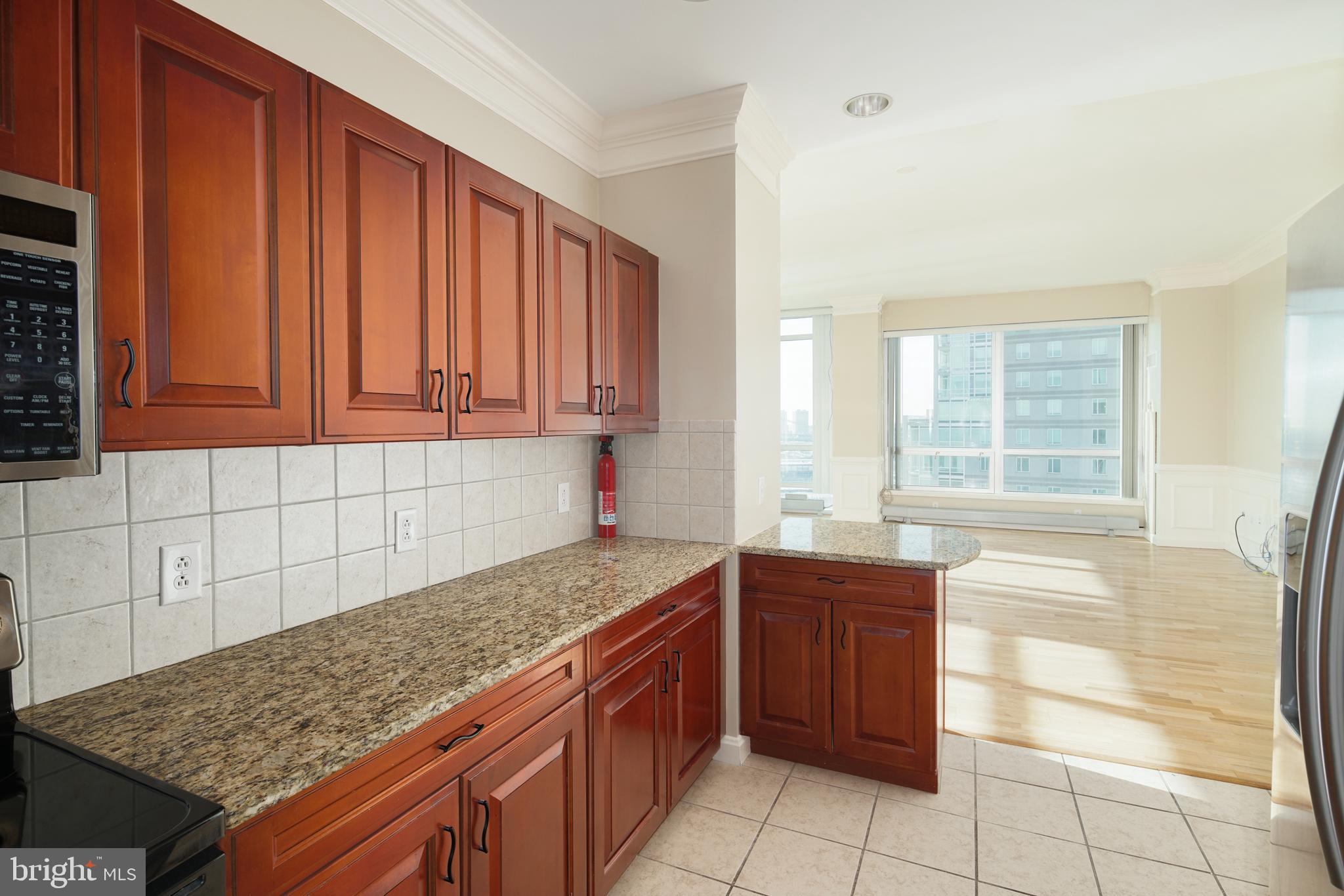 901 North Penn Street, Unit R1902 Philadelphia, PA 19123 - Photo 14 of 34 a kitchen with a sink a stove and cabinets