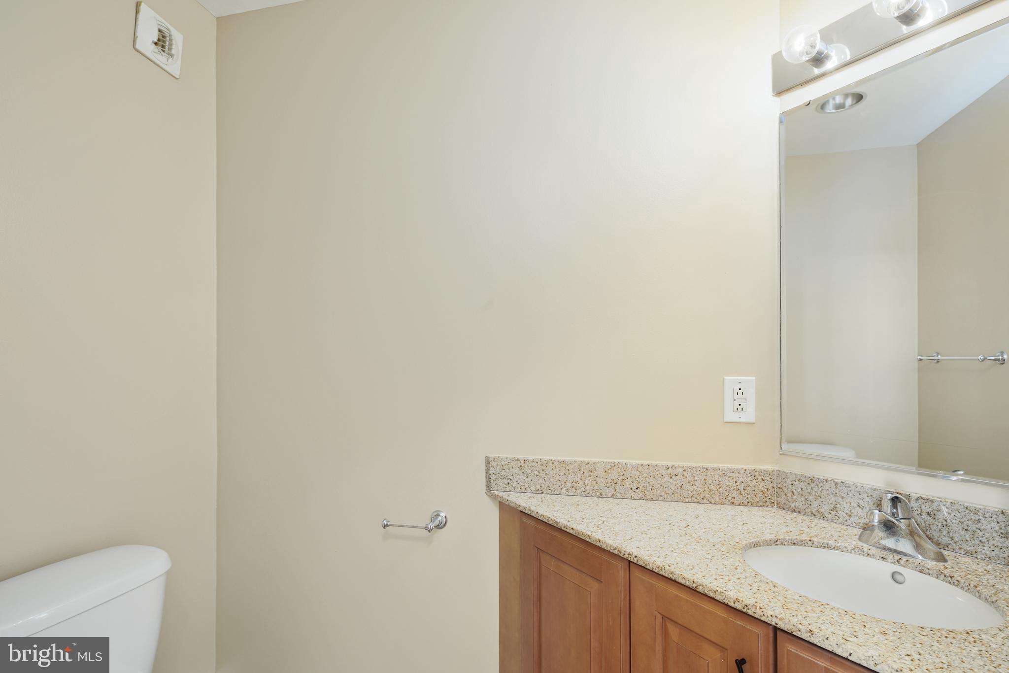 901 North Penn Street, Unit R1902 Philadelphia, PA 19123 - Photo 16 of 34 a bathroom with a granite countertop sink and a mirror