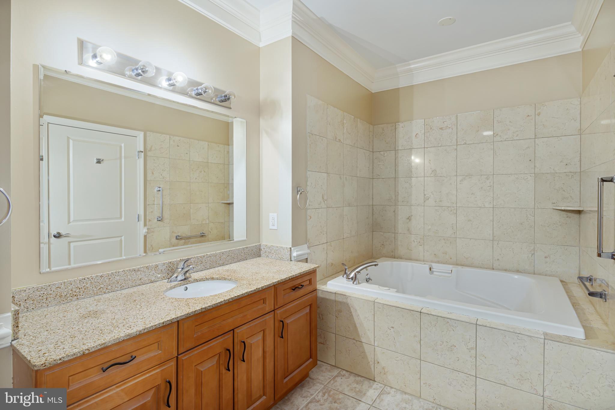 901 North Penn Street, Unit R1902 Philadelphia, PA 19123 - Photo 24 of 34 a bathroom with a tub sink and mirror