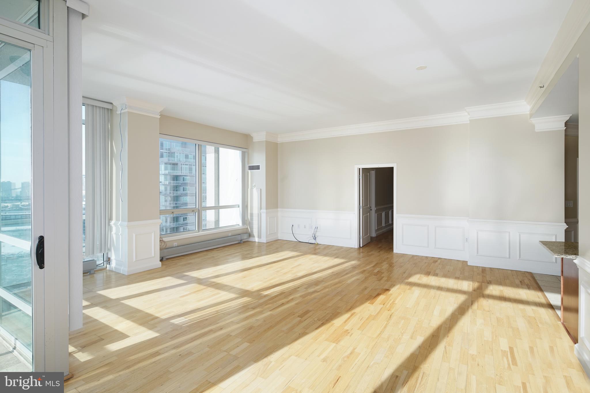 901 North Penn Street, Unit R1902 Philadelphia, PA 19123 - Photo 8 of 34 a view of an empty room with wooden floor and a window