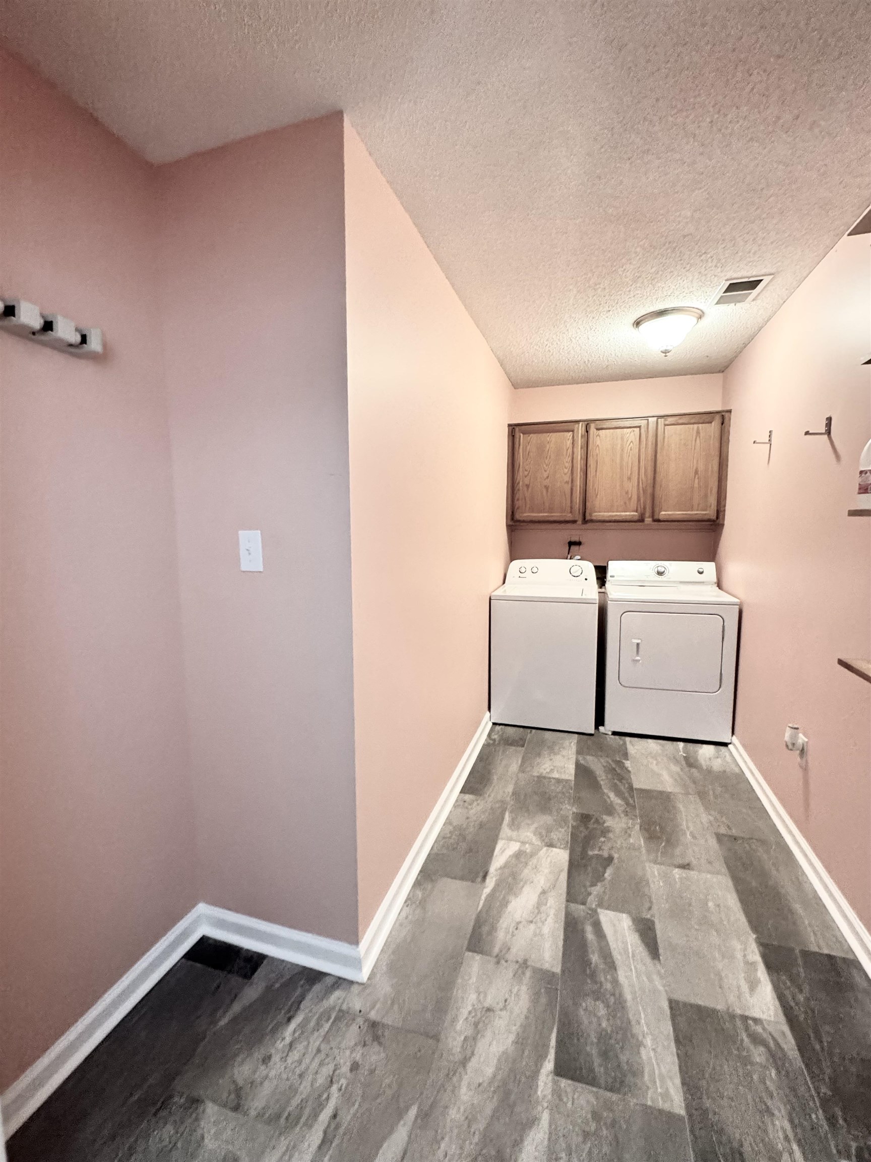 641 Hermitage Trail Collierville, TN 38017 - Photo 24 of 24 Dedicated laundry area featuring wood-finish flooring, overhead cabinetry, and a ceiling-mounted light fixture
