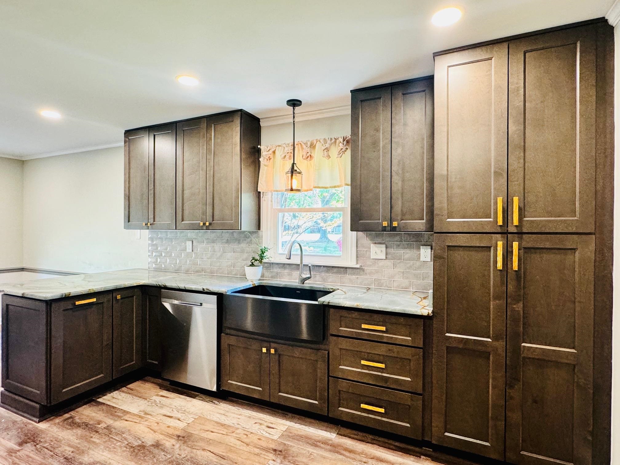 641 Hermitage Trail Collierville, TN 38017 - Photo 7 of 24 Kitchen featuring a peninsula, ornamental molding, light stone countertops, light wood-style floors, and stainless steel dishwasher