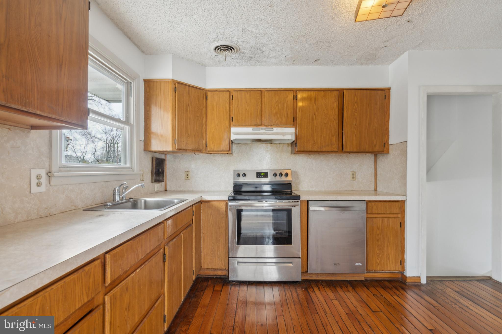 107 Surrey Road Voorhees, NJ 08043 - Photo 9 of 25 a kitchen with a sink stove and cabinets