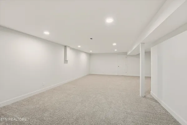 a view of empty room with a fireplace