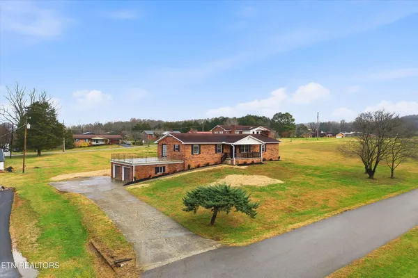 an aerial view of a house with swimming pool and patio