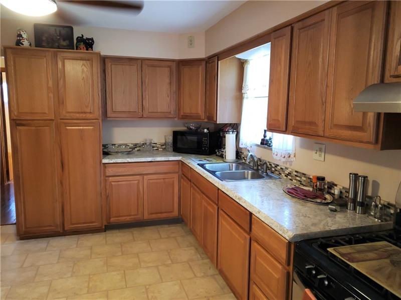 144 Jacks Run Road Pittsburgh, PA 15214 - Photo 5 of 21 Large kitchen remodeled in 2017. Cabinet next to sink is made to conveniently slide out if you prefer to have a dishwasher