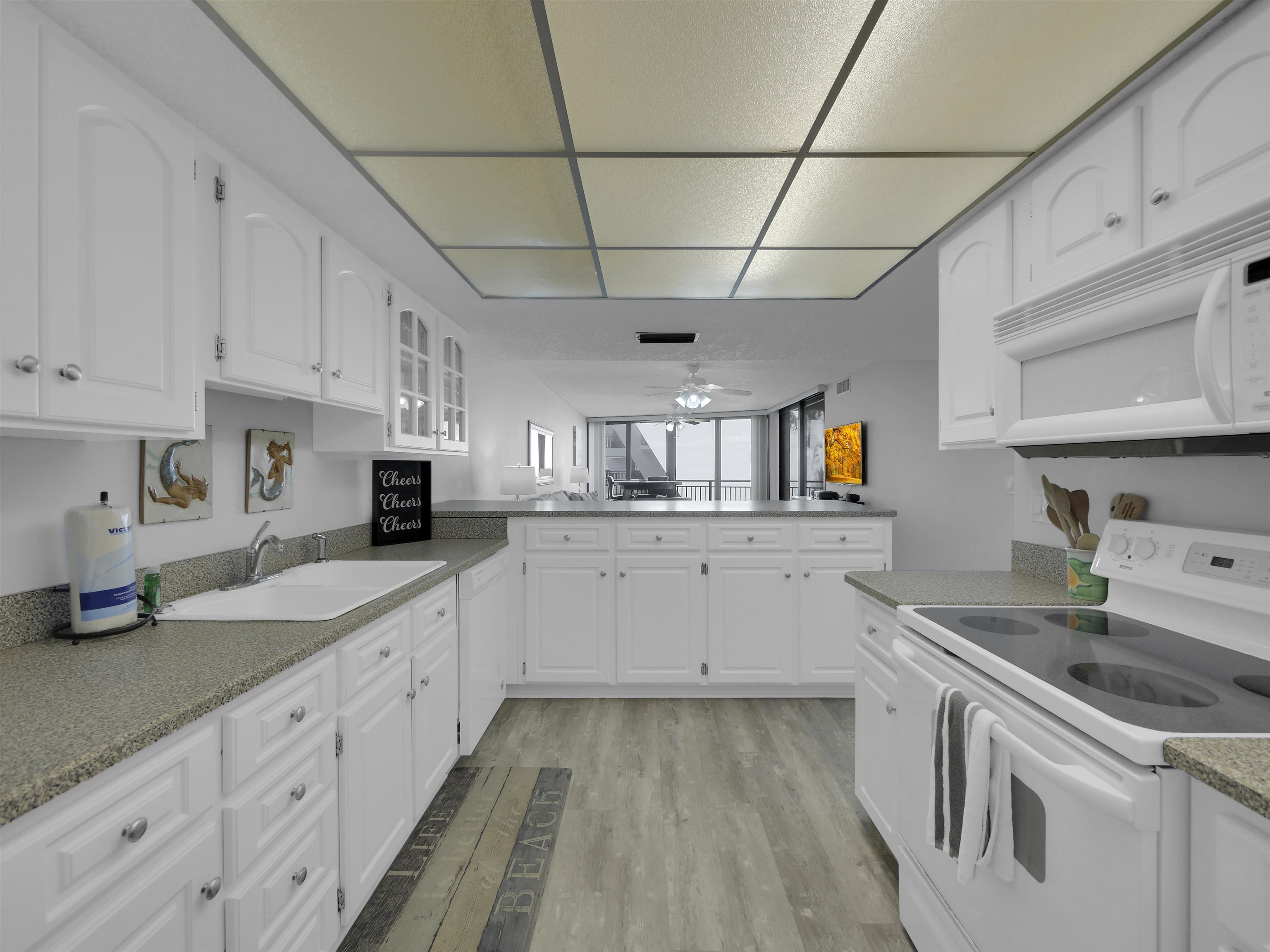 2 Dondanville Road, Unit 211 St. Augustine, FL 32080 - Photo 11 of 30 a kitchen with granite countertop white cabinets and white appliances