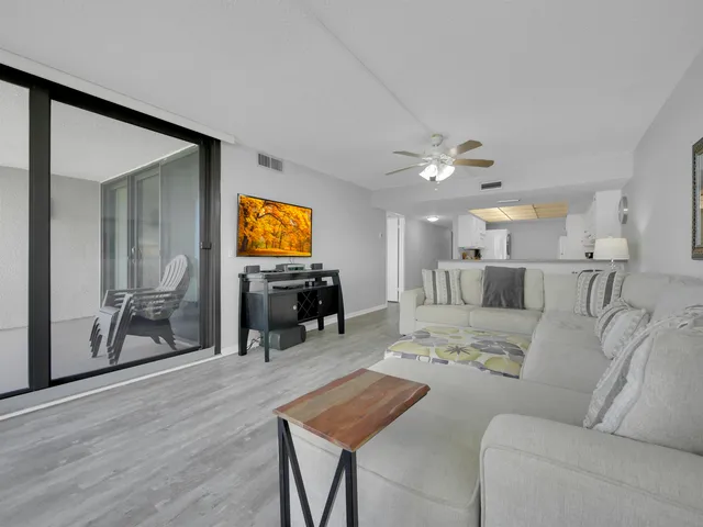 a view of a livingroom with furniture and a flat screen tv