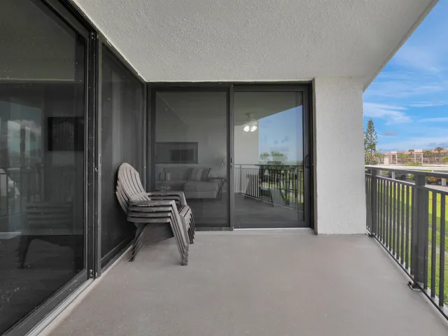 a balcony with chairs and a table