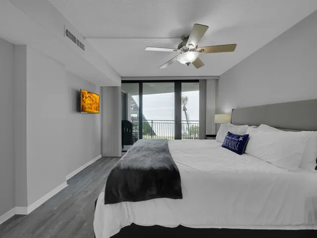 a bedroom with a large bed and a large window