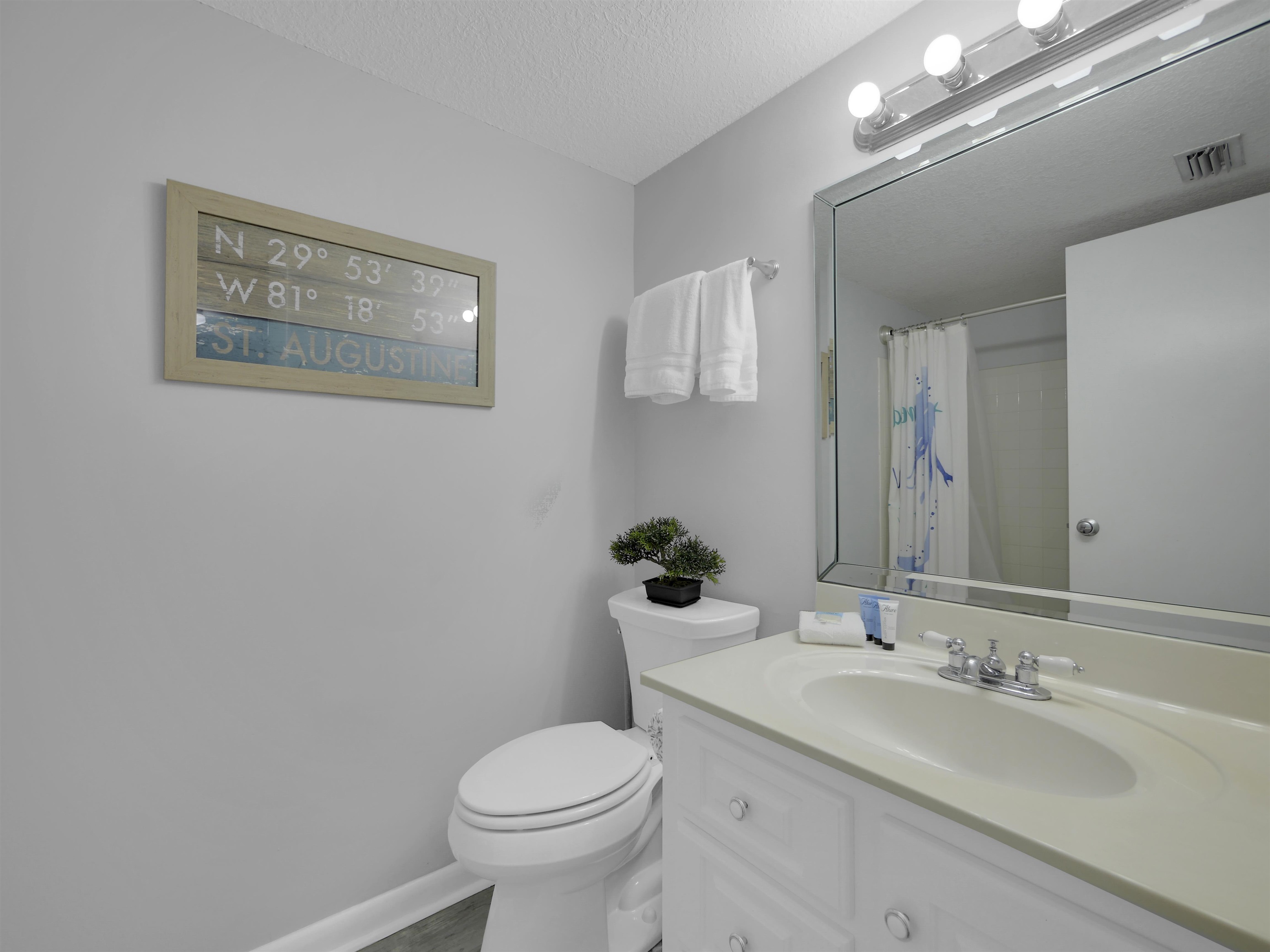 2 Dondanville Road, Unit 211 St. Augustine, FL 32080 - Photo 25 of 30 a bathroom with a toilet a sink and mirror