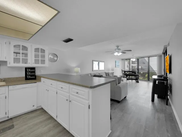 a kitchen with white cabinets and sink