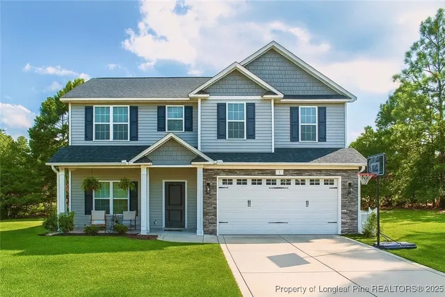 a front view of a house with a yard and garage