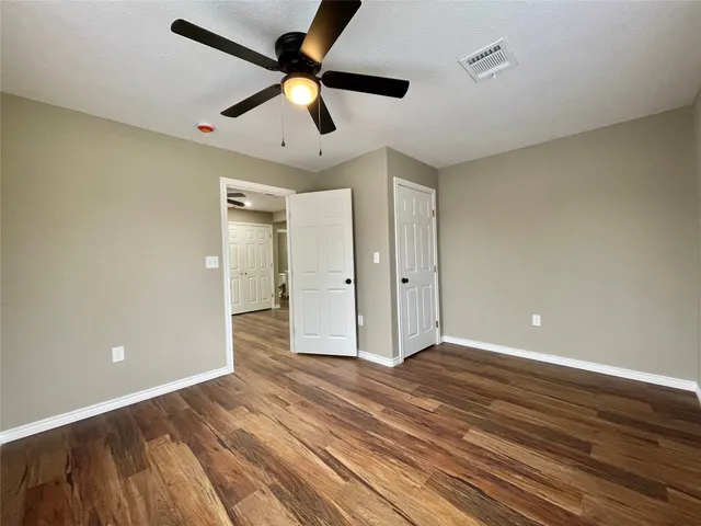 a view of an empty room and wooden floor