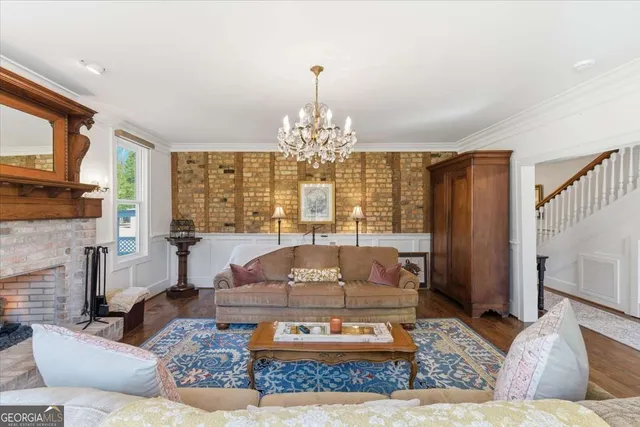 a living room with furniture a rug and a large window