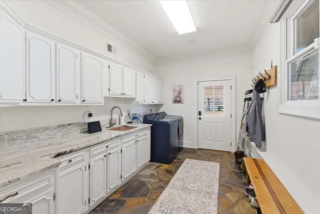 a living room with furniture a floor to ceiling window and wooden floor