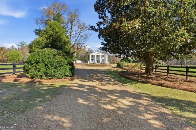 a view of a house with swimming pool and a yard