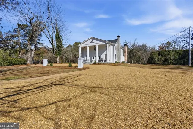 a living room with furniture chandelier and a window