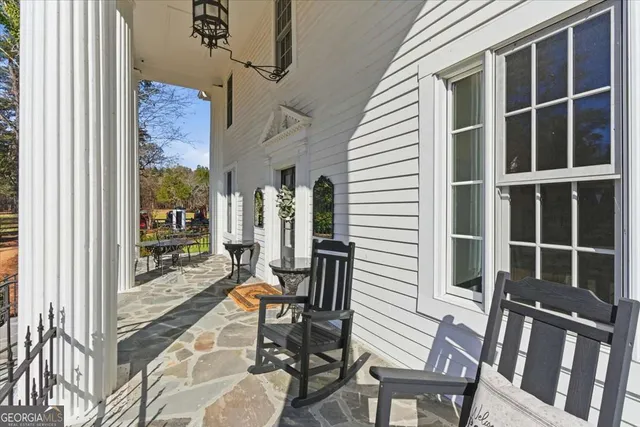 a kitchen with a dining table chairs and refrigerator