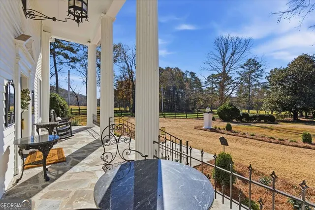 a kitchen with a dining table cabinets and appliances