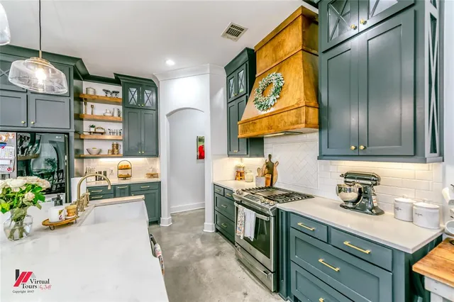 a kitchen with stainless steel appliances granite countertop a sink and cabinets