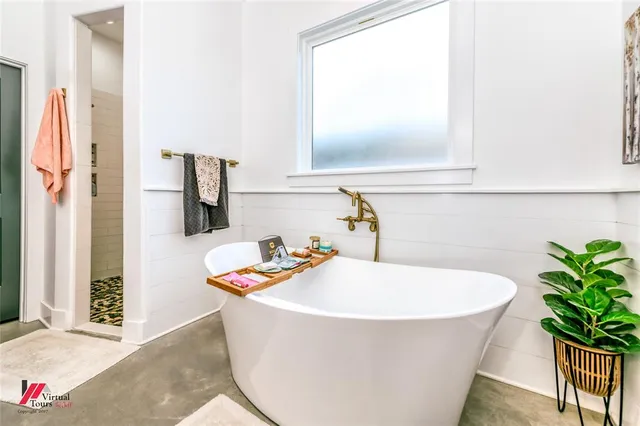 a bathroom with a tub and mirror