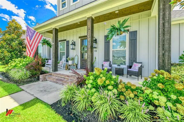 a front view of a house with a chairs and table in a patio