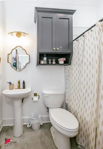 a bathroom with a sink a toilet and a mirror