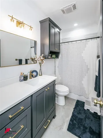 a bathroom with a sink a toilet and a mirror