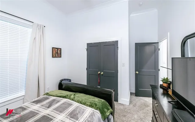 a bedroom with a bed and a flat screen tv