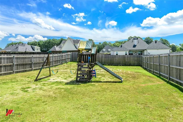a view of a swimming pool with a patio and a yard