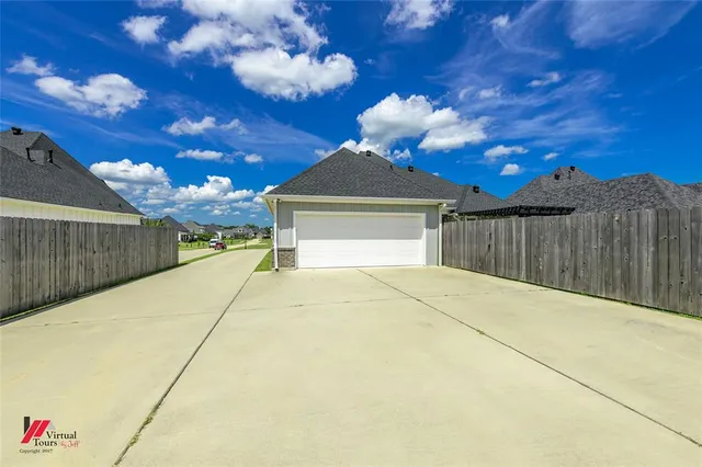 a view of backyard with wooden fence