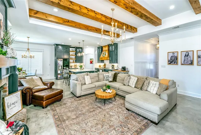a living room with furniture a rug and a chandelier