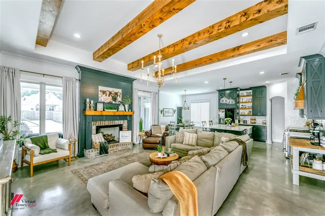 a living room with fireplace furniture and a large window