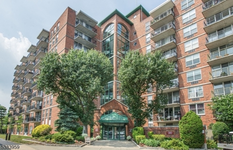 300 Main Street, Unit 716 Little Falls, NJ 07424 - Photo 1 of 24 a front view of a multi story building with a yard