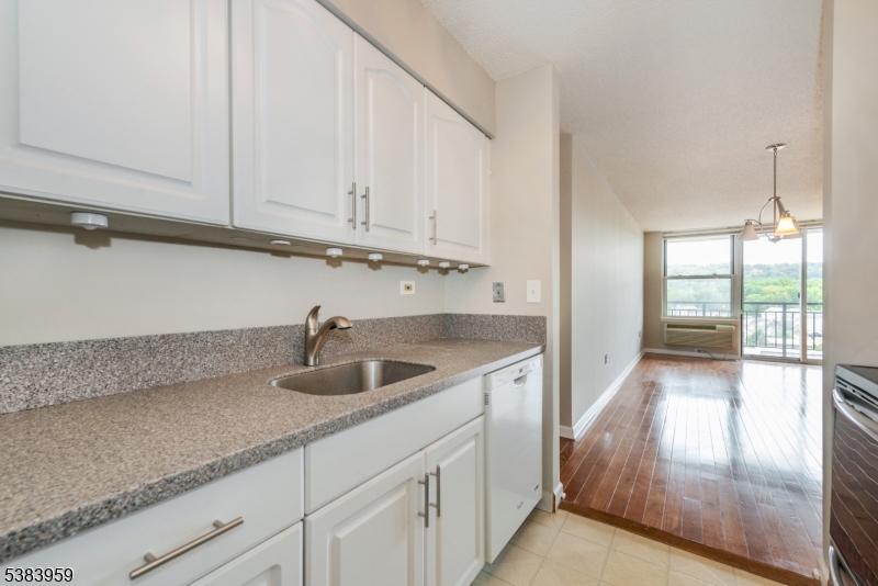 300 Main Street, Unit 716 Little Falls, NJ 07424 - Photo 11 of 24 a kitchen with a sink and cabinets