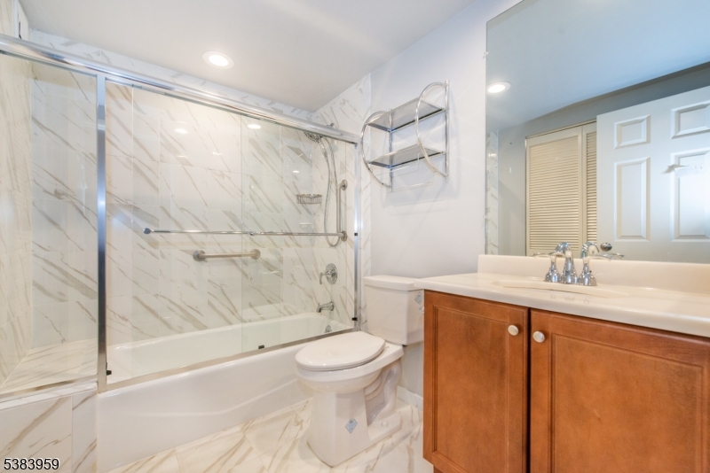 300 Main Street, Unit 716 Little Falls, NJ 07424 - Photo 12 of 24 a bathroom with a granite countertop sink toilet and shower