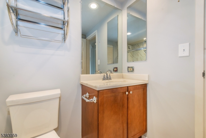 300 Main Street, Unit 716 Little Falls, NJ 07424 - Photo 14 of 24 a bathroom with a sink and a toilet