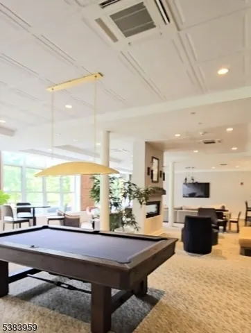 a kitchen with stainless steel appliances kitchen island granite countertop a sink counter space and living room view