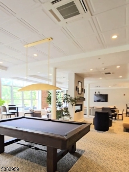 300 Main Street, Unit 716 Little Falls, NJ 07424 - Photo 23 of 24 a kitchen with stainless steel appliances kitchen island granite countertop a sink counter space and living room view