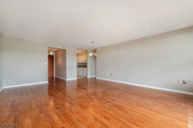 a view of an empty room and wooden floor
