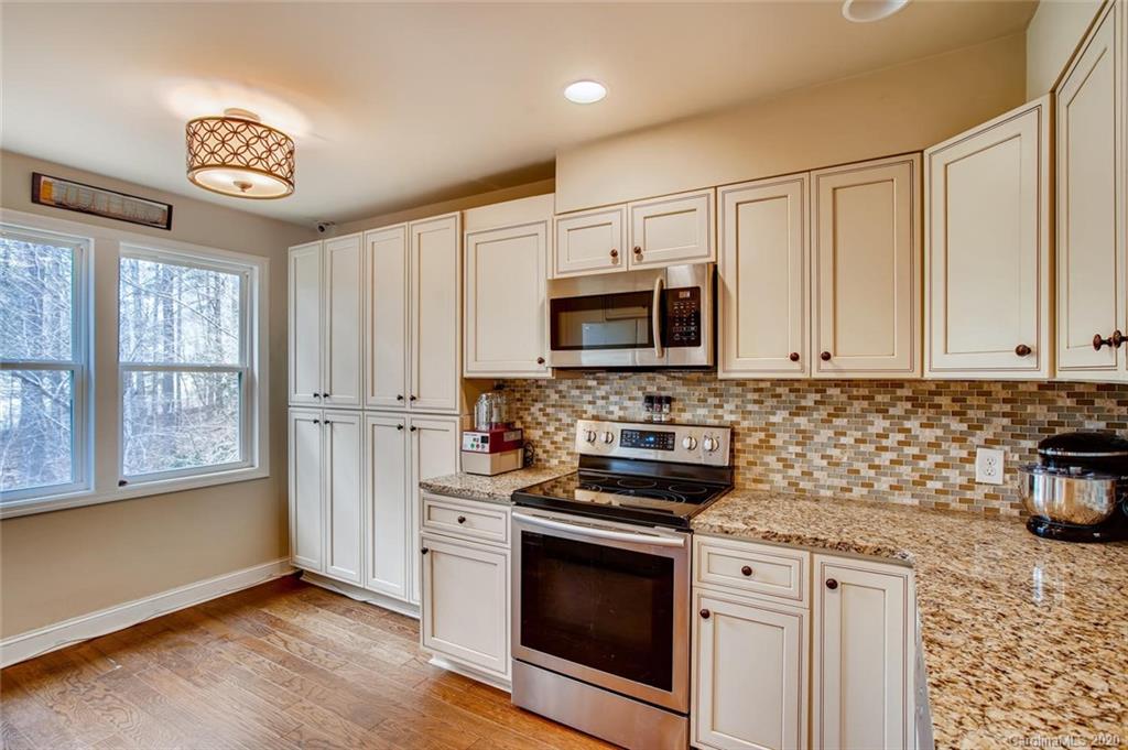 2147 Manawa Lane Tega Cay, SC 29708 - Photo 11 of 28 a kitchen with stainless steel appliances granite countertop a stove a sink and a microwave