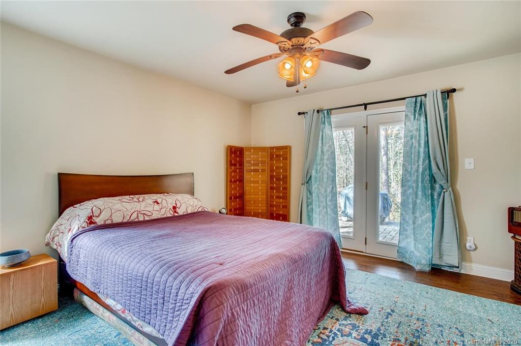 2147 Manawa Lane Tega Cay, SC 29708 - Photo 14 of 28 a bedroom with a large bed and a chandelier