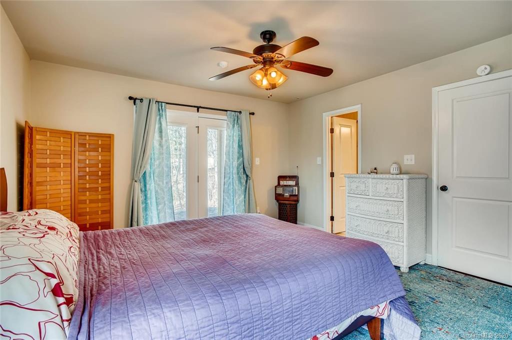 2147 Manawa Lane Tega Cay, SC 29708 - Photo 15 of 28 a bedroom with a large bed and a chandelier