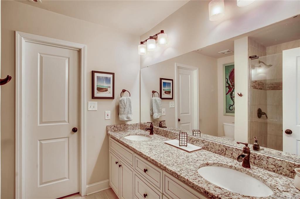 2147 Manawa Lane Tega Cay, SC 29708 - Photo 16 of 28 a bathroom with a granite countertop double vanity sink and mirror