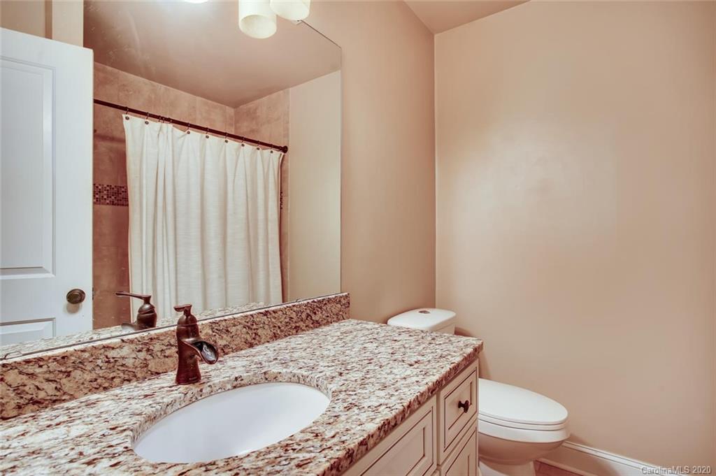 2147 Manawa Lane Tega Cay, SC 29708 - Photo 19 of 28 a bathroom with a granite countertop sink and a mirror