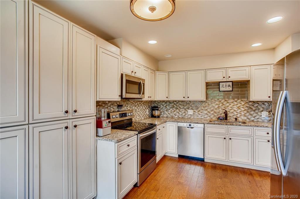 2147 Manawa Lane Tega Cay, SC 29708 - Photo 7 of 28 a kitchen with stainless steel appliances granite countertop a stove a sink and a refrigerator