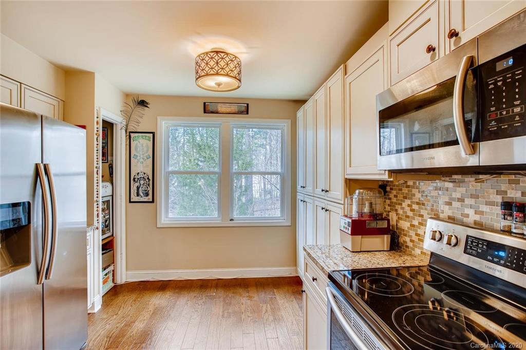 2147 Manawa Lane Tega Cay, SC 29708 - Photo 9 of 28 a kitchen with stainless steel appliances granite countertop a stove and a refrigerator